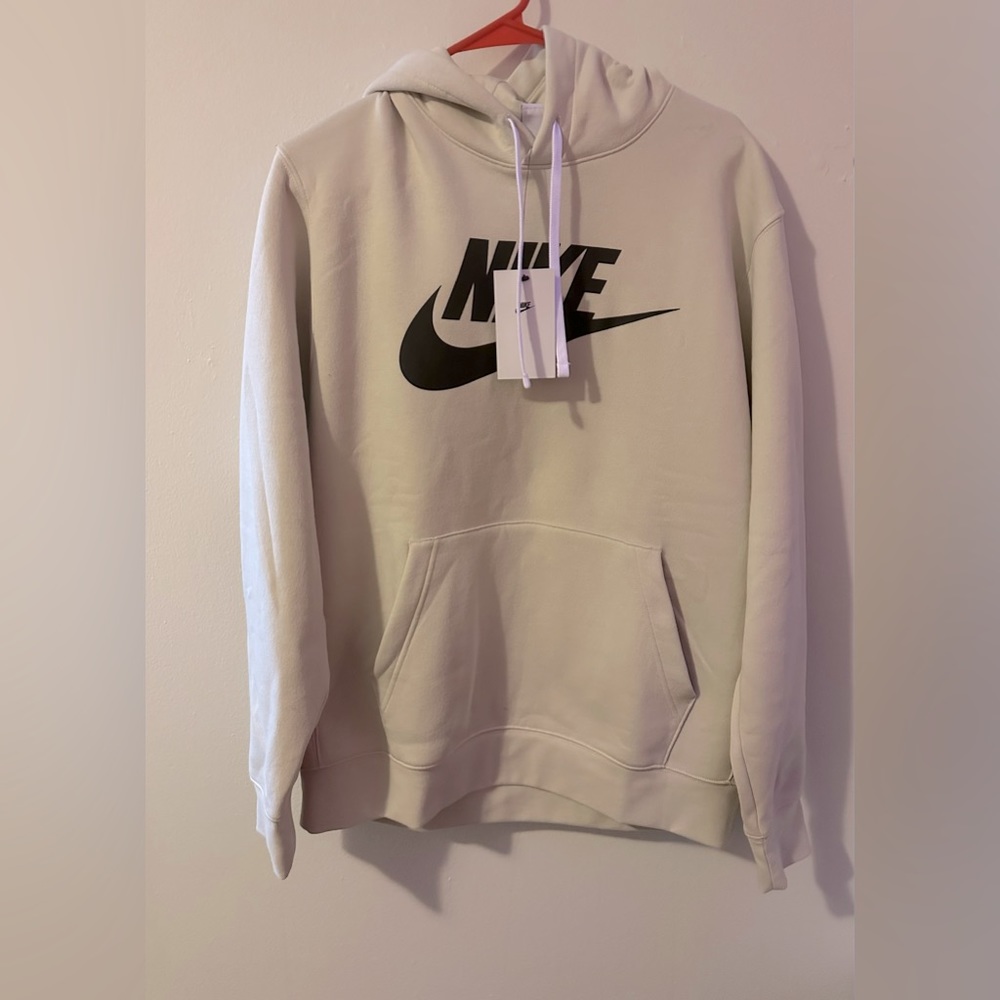 Brand New Large Nike Hoodie. (NWT)! Cream colored, with a black Nike swoosh.